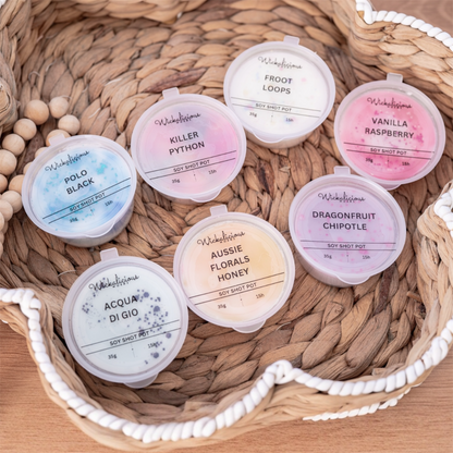 Assorted soy shot pots with labels in a woven basket